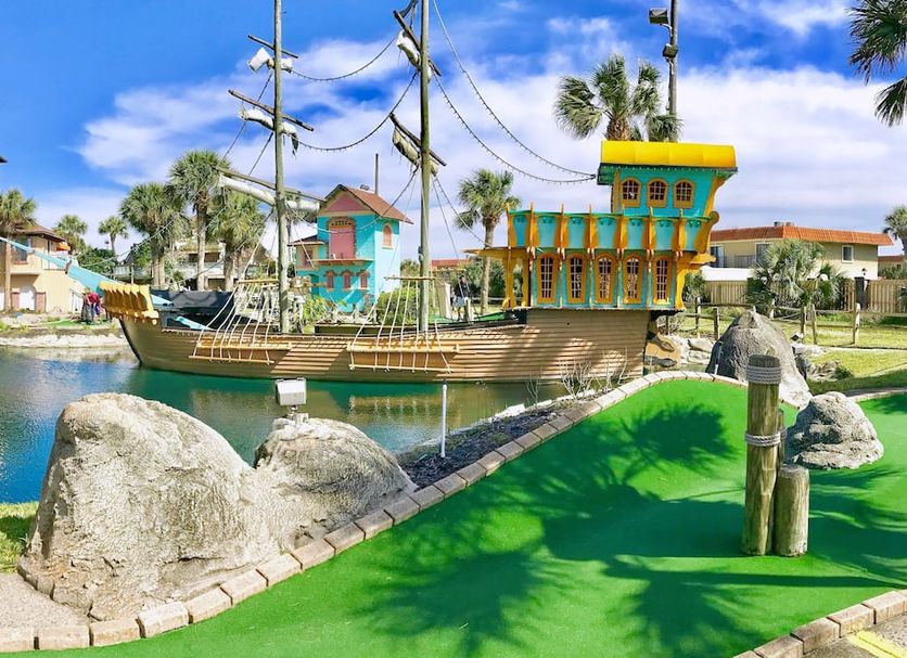 La Fiesta Ocean Inn And Suites in St. Augustine with pirate ship mini golf beside a lagoon