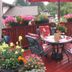 The Grateful Bed B'n'B in Prince George features a flower-filled deck with patio table and red umbrella