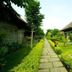 Halez Sparsa Thiruvannamalai in Tiruvannamalai with stone walkway, manicured lawns, and thatched cottages