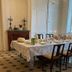 Dining room at YXIE - manoir des arts in Villeblevin with a set table, chairs and tall windows