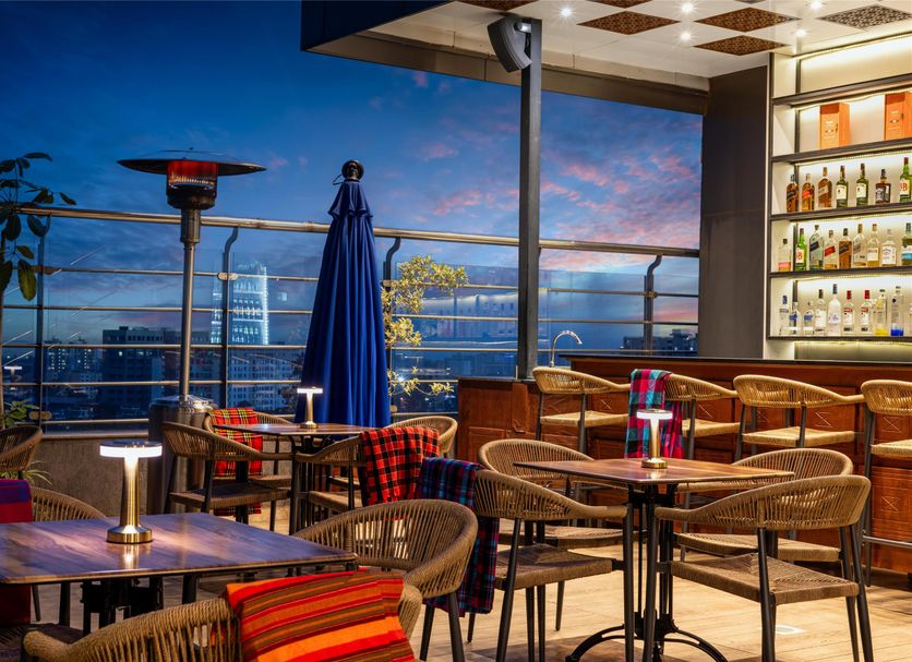 Golden Tulip Westlands Nairobi rooftop bar terrace with city skyline views at dusk