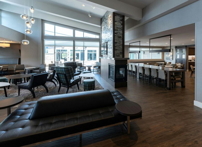 Residence Inn by Marriott Wilkes-Barre Arena lobby with seating, fireplace, and bar area in Wilkes-Barre