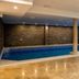 Indoor pool at Hotel Blanca Resort & Spa in Šišava with stone details and large windows