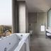 Mercure Chandigarh Tribune Chowk bathroom with soaking tub, glass shower, double vanity and city view