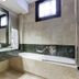 Borgo Palace Hotel in Sansepolcro bathroom with bathtub, large mirror, and marble tile walls