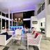 Sand & Sandals Desaru Beach Resort & Spa lobby with blue-lit bar, white seating and high ceilings in Bandar Penawar