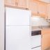 Hawthorn Extended Stay by Wyndham Conyers kitchen with refrigerator, microwave, dishwasher, and wood cabinets