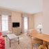 Hawthorn Extended Stay by Wyndham Conyers guest room with seating area, desk, TV and twin windows