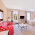 Hawthorn Extended Stay by Wyndham Conyers guest room with two beds, sofa, TV, and windows