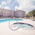 Hawthorn Extended Stay by Wyndham Conyers pool and hot tub with hotel building in Conyers