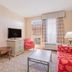 Hawthorn Extended Stay by Wyndham Conyers guest room with sofa, TV, table, and window view