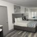Casa Loma in Panama City Beach: hotel room with two beds, window shutters, TV, and small desk