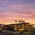 Holiday Inn Express & Suites Ventura Harbor By IHG exterior at sunset in Ventura with lit balconies