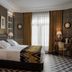 Relais & Châteaux Heritage Hotel Madrid guest room with king bed, desk and patterned walls