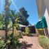 Newlands Guest House, Cape Town courtyard with tropical plants, brick path, and mountain backdrop