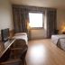 Hotel Domo in Vilafranca del Penedès room with two beds, desk, TV, and window with curtains