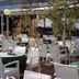 Hotel Caravelle in Jesolo outdoor terrace with white chairs and tables under trees