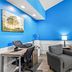 Baymont by Wyndham Forest City room with bright blue walls, desk, chair, sofa and armchair