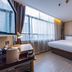 Home Inn Neo Changzhou Wanda Plaza Tongjiang Avenue room with large window, desk and neatly made bed in Changzhou