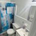 Uptown Inn & Suites in St. Petersburg bathroom with blue patterned shower curtain, toilet and sink