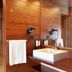 Montanya Hotel & Lodge in Seva bathroom with wood walls, double sink, and walk-in shower