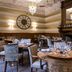 Mercure Aberdeen Ardoe House dining room in Aberdeen with round set tables, chandeliers and wood paneling