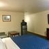 Passport Inn and Suites - Middletown guest room with bed, TV, mini fridge and microwave