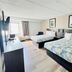 Motel 6 Milford Ct guest room with two beds, TV, and window in Milford