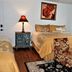 1895 Washington Hotel in Paducah guest room with king bed, floral chairs, lamp, and window light