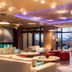 Ibis Styles Riga lounge with colorful seating, circular tables, and large windows in Riga