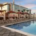 Hilton Garden Inn Chandler Downtown pool terrace with lounge chairs and cabanas in Chandler