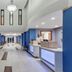 Holiday Inn Express & Suites Elk Grove West I-5 lobby with front desk and seating area