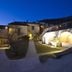 Agriturismo Il Casale Degli Amici in Norcia courtyard at dusk with lit stone buildings and gravel paths