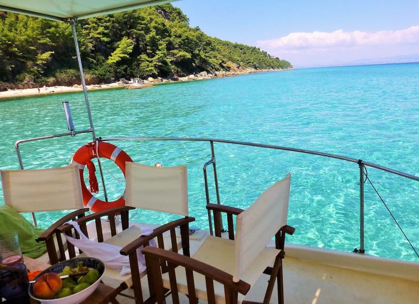 Akrogiali Exclusive Hotel in Polychrono with a boat deck overlooking turquoise sea and shoreline