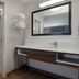 Hampton Inn & Suites Billings West I-90 bathroom with glass shower, toilet, and vanity sink in Billings