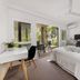 Sunset Cove Noosa, Noosaville: bright bedroom with king bed, desk and balcony to outdoor seating