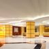 Power Valley International Hotel in Baoding lobby with gold columns, curved ceiling lights, and marble floor