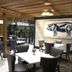 The Burgundy Hotel, Tapestry Collection by Hilton in Little Rock lounge with tables, chairs and cow artwork