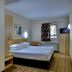 Road Lodge Bloemfontein Airport room with double bed, window, TV, and en-suite bathroom