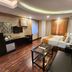 Housez 43 Kolkata guest room with king bed, desk, sofa and wood flooring