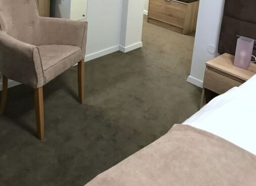 Sobes Zagreb guest room with chair, mirror, built-in wardrobe, and bed in a compact interior