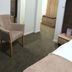 Sobes Zagreb guest room with chair, mirror, built-in wardrobe, and bed in a compact interior