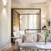 Myr Palacio Vallier Valencia suite with canopy bed, sofa, and elegant wall sconces