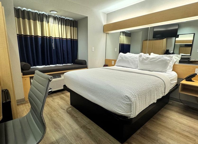 Microtel Inn & Suites by Wyndham Albertville room with king bed, window seat, and desk