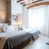 LE 5 Terre La Spezia guest room with two beds, exposed stone wall, and bright window