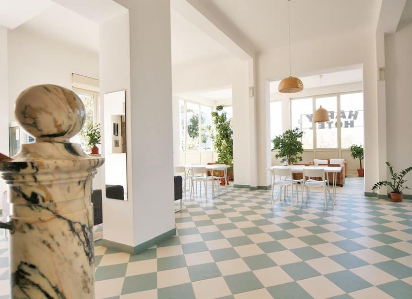 Hotel Happy in Marina Di Pietrasanta lobby with checkered floor, seating area and bright windows