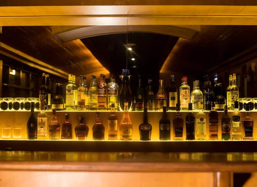 Hotel Kodai International bar shelf with illuminated liquor bottles in Kodaikanal