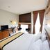 Hotel Nyland Pasteur Bandung guest room with bed, desk, TV, and window curtains in Bandung