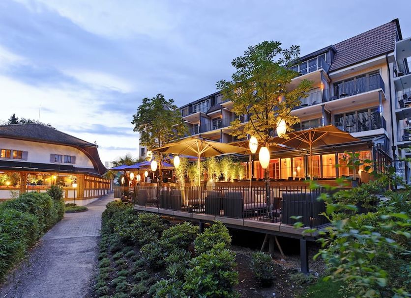 Seerose Resort & Spa in Meisterschwanden with lakeside terrace and illuminated outdoor dining area