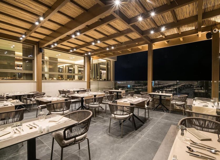 King Minos Retreat Resort & Spa in Hersonissos rooftop restaurant with open-air city views
